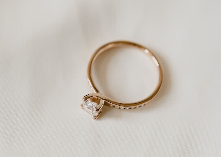 Side stone ring in 18K gold with a 0.5-carat center diamond from VANBRUUN